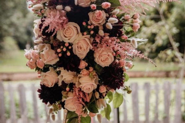 Blush and Burgundy Bloemstuk met grote dahlia's, bordeau echiveria's, sweet avalanche rozen en bordeaux skimia's